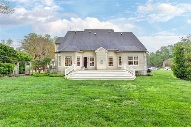 rear view of property with a lawn and a deck