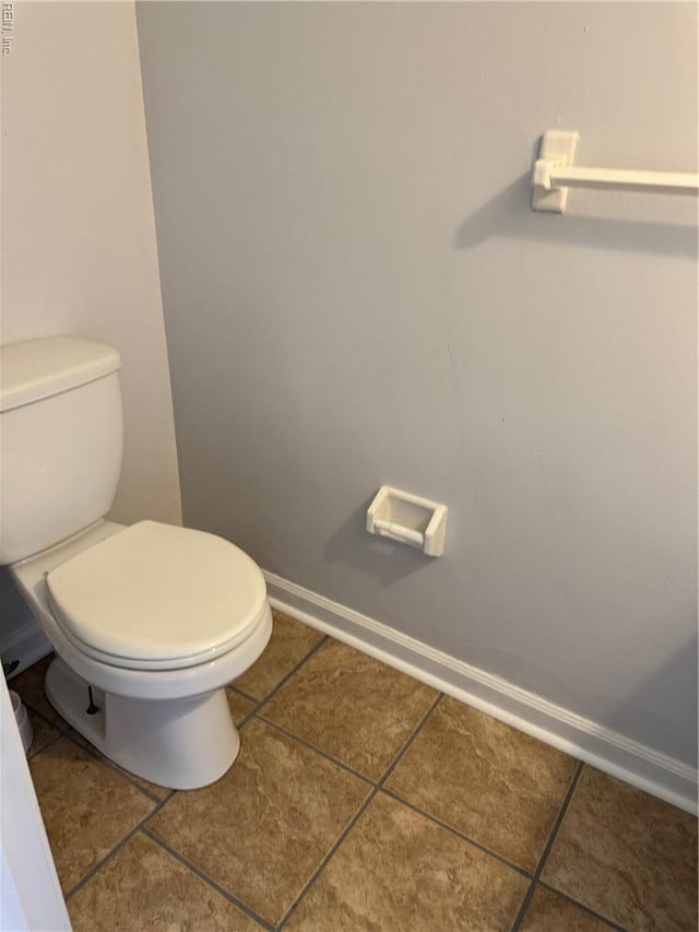 3413 Wheatfield Ct, Portsmouth, VA 23703 - bathroom with tile patterned floors, toilet, and baseboards