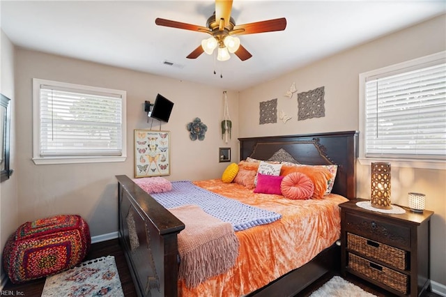bedroom with visible vents, baseboards, and a ceiling fan