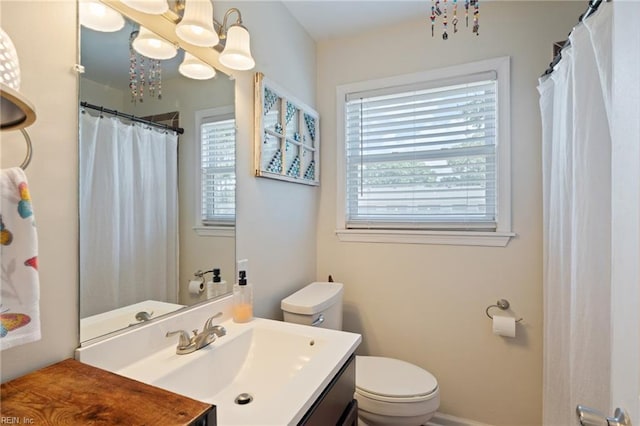 full bath with toilet, a chandelier, and vanity