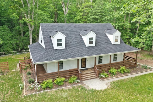 490 Poplar Lawn Rd, Surry, VA 23883 - cape cod home with a porch, a forest view, a shingled roof, and fence