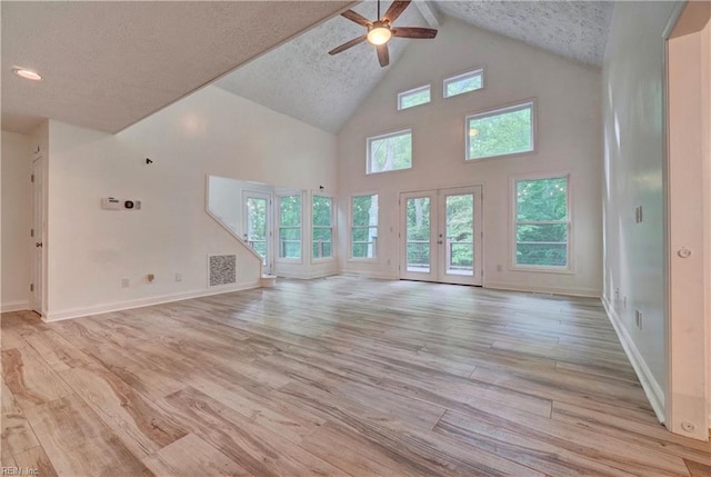 490 Poplar Lawn Rd, Surry, VA 23883 - unfurnished living room with a ceiling fan, baseboards, light wood finished floors, high vaulted ceiling, and beam ceiling