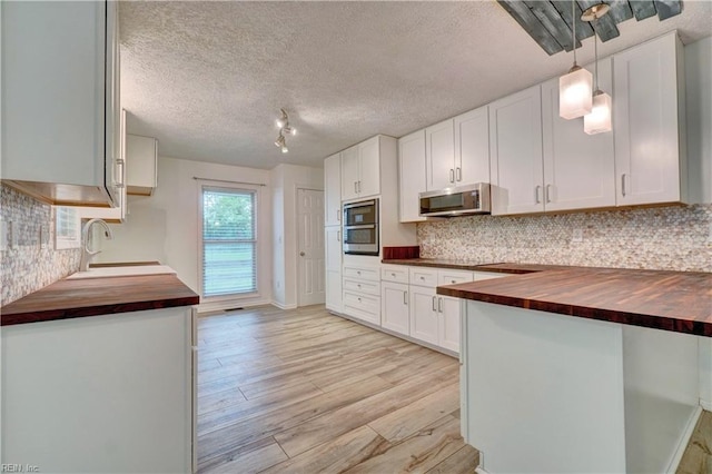 490 Poplar Lawn Rd, Surry, VA 23883 - kitchen with a sink, stainless steel appliances, tasteful backsplash, butcher block counters, and light wood-style floors