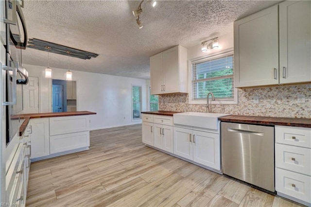 490 Poplar Lawn Rd, Surry, VA 23883 - kitchen with wood counters, backsplash, stainless steel dishwasher, and a sink