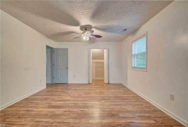490 Poplar Lawn Rd, Surry, VA 23883 - unfurnished bedroom with baseboards, visible vents, a textured ceiling, and wood finished floors