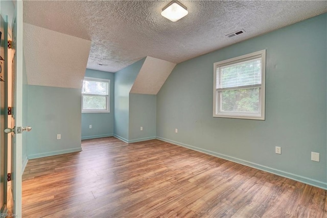 490 Poplar Lawn Rd, Surry, VA 23883 - bonus room with a textured ceiling, visible vents, wood finished floors, and baseboards