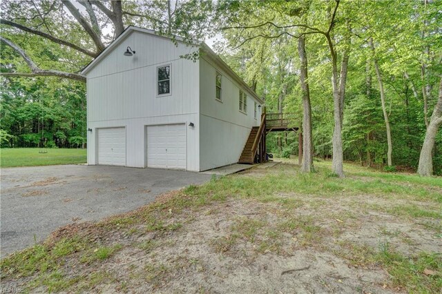 490 Poplar Lawn Rd, Surry, VA 23883 - view of side of home featuring stairs, a garage, a deck, and driveway