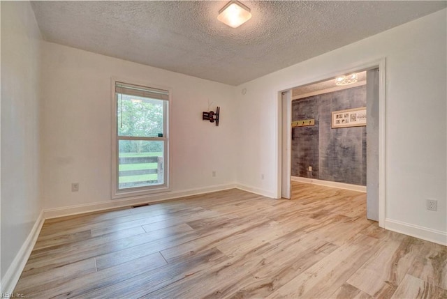490 Poplar Lawn Rd, Surry, VA 23883 - empty room featuring baseboards, light wood-style flooring, and a textured ceiling