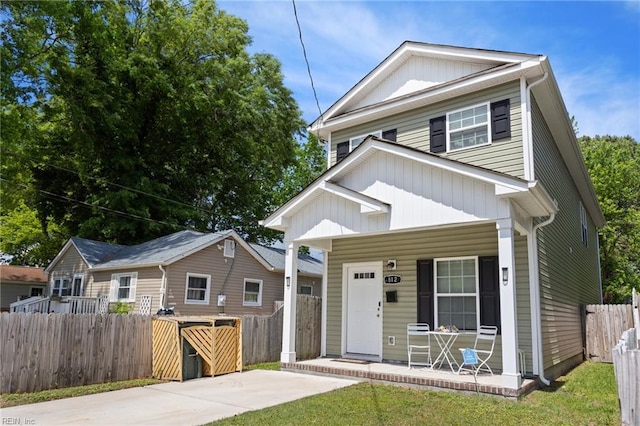 view of front of house featuring a porch, fence, and board and batten siding