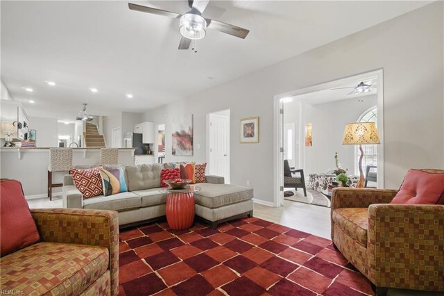 living area featuring a ceiling fan, stairs, recessed lighting, and baseboards