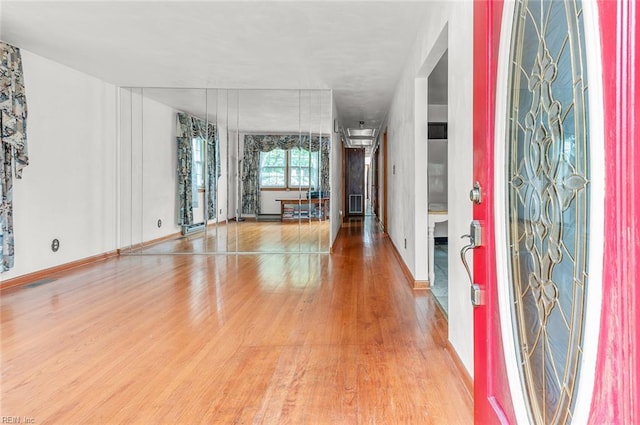 foyer with wood finished floors and baseboards