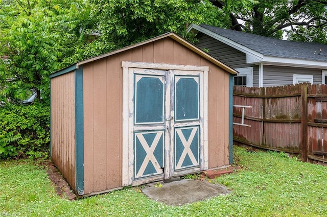view of shed with fence