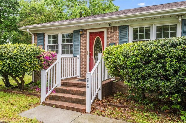 property entrance with brick siding