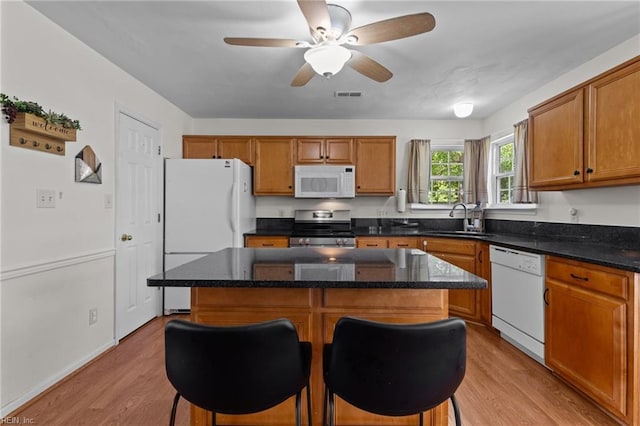 1409 Shady Tree Way, Chesapeake, VA 23323 - kitchen featuring white appliances, a sink, light wood-style floors, a kitchen bar, and ceiling fan