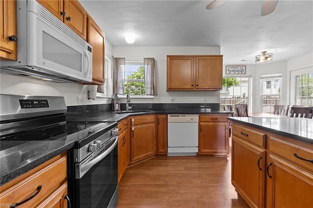 1409 Shady Tree Way, Chesapeake, VA 23323 - kitchen with white appliances, a sink, brown cabinetry, and wood finished floors