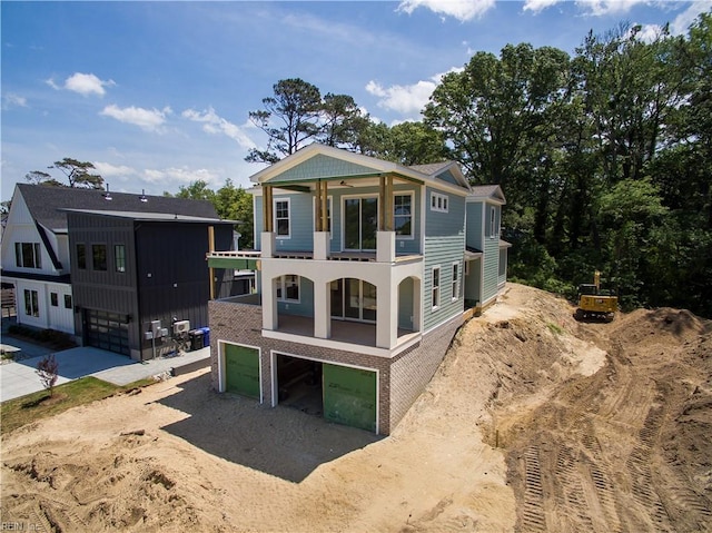 402 48th St, Virginia Beach, VA 23451 - rear view of house featuring driveway, an attached garage, and a balcony