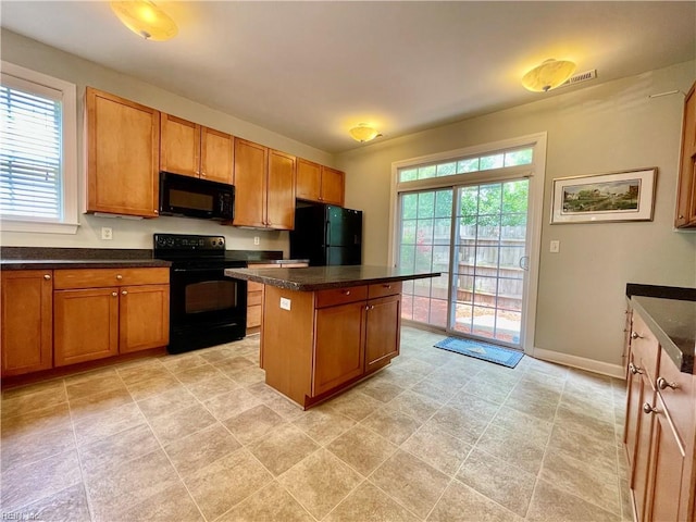 452 Blue Beech Way, Chesapeake, VA 23320 - kitchen with black appliances, a center island, healthy amount of natural light, and dark countertops