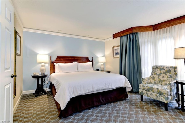 carpeted bedroom featuring crown molding and baseboards