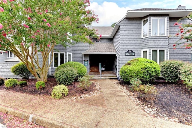 view of front of home featuring roof with shingles