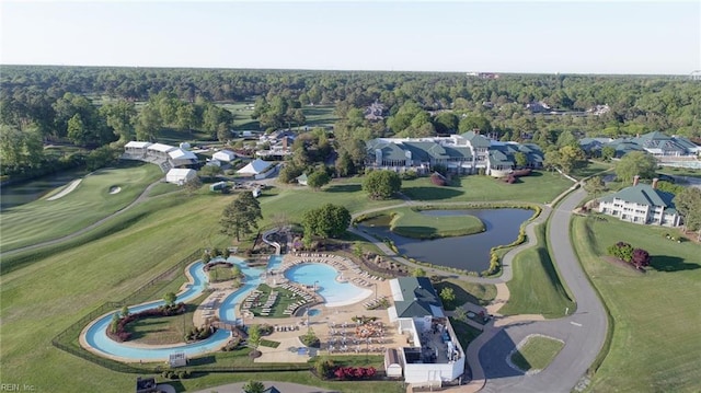 drone / aerial view featuring a wooded view, a water view, and golf course view