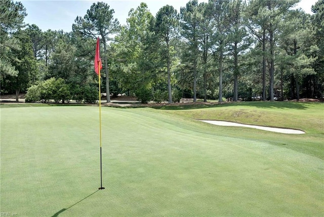 view of community featuring a yard and golf course view