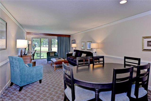 carpeted dining room featuring ornamental molding and baseboards