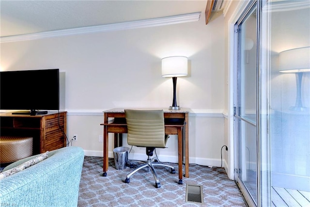 carpeted office space featuring visible vents, baseboards, and ornamental molding