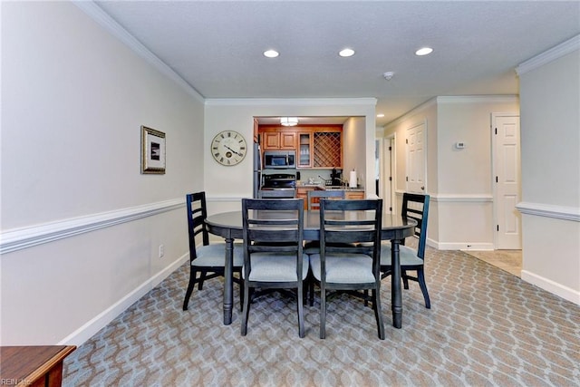 dining room featuring crown molding, light carpet, and recessed lighting