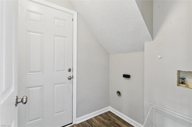 laundry area with a textured ceiling, hookup for a washing machine, electric dryer hookup, dark wood finished floors, and baseboards