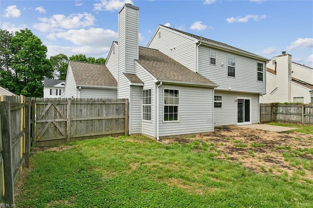 rear view of property featuring a shingled roof and a chimney