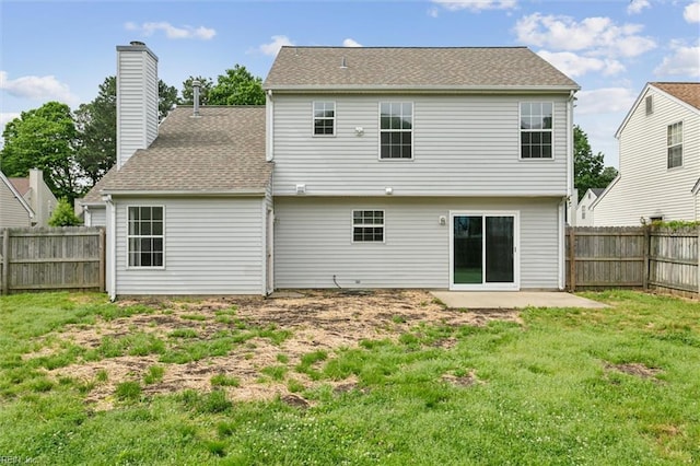 rear view of house with a chimney and a patio area