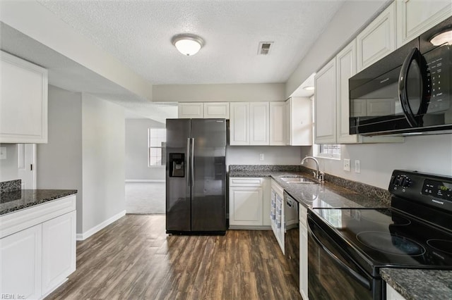 kitchen featuring black appliances, a sink, white cabinetry, and a textured ceiling