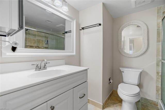 500 Pacific Ave Unit 812, Virginia Beach, VA 23451 - bathroom featuring baseboards, toilet, a tile shower, tile patterned flooring, and vanity