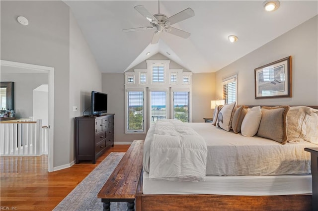bedroom featuring baseboards, high vaulted ceiling, a ceiling fan, and wood finished floors