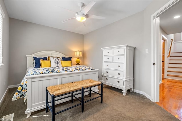 bedroom featuring a ceiling fan, carpet floors, baseboards, and visible vents
