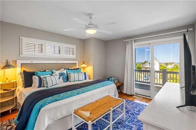 bedroom with visible vents, wood finished floors, access to exterior, and ceiling fan