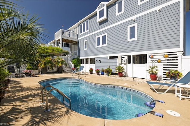 view of swimming pool with stairs, a patio, a fenced in pool, and fence