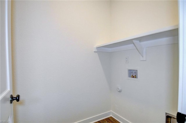 laundry area with laundry area, baseboards, hookup for a washing machine, and wood finished floors