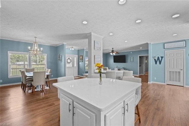 108 Hodges Cove Rd, Yorktown, VA 23692 - kitchen with wood finished floors, a chandelier, white cabinets, a textured ceiling, and a center island