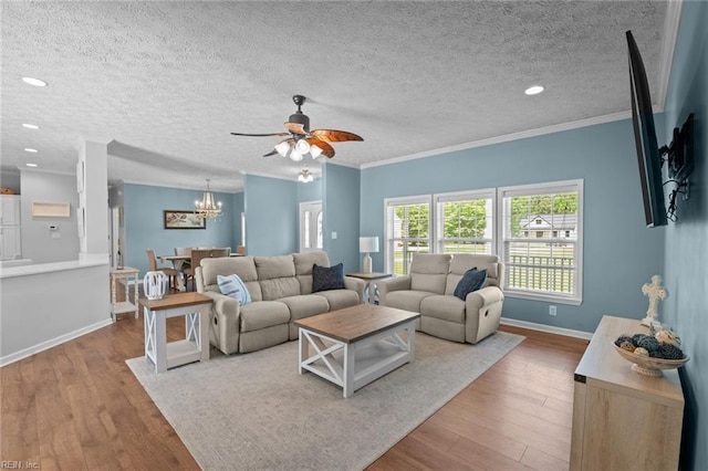 108 Hodges Cove Rd, Yorktown, VA 23692 - living area with a chandelier, a ceiling fan, wood finished floors, ornamental molding, and baseboards