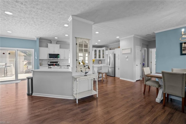108 Hodges Cove Rd, Yorktown, VA 23692 - kitchen featuring stainless steel appliances, dark wood-style floors, white cabinets, decorative backsplash, and light countertops