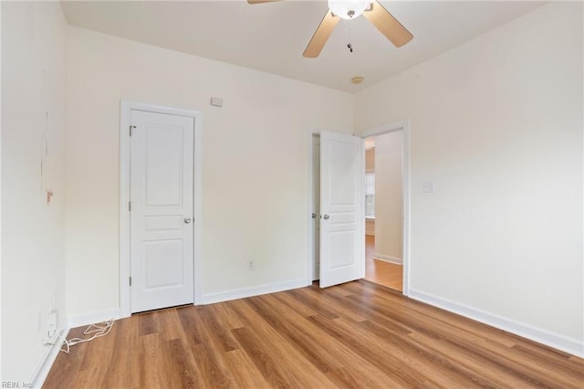 unfurnished bedroom featuring ceiling fan, baseboards, and light wood-style floors