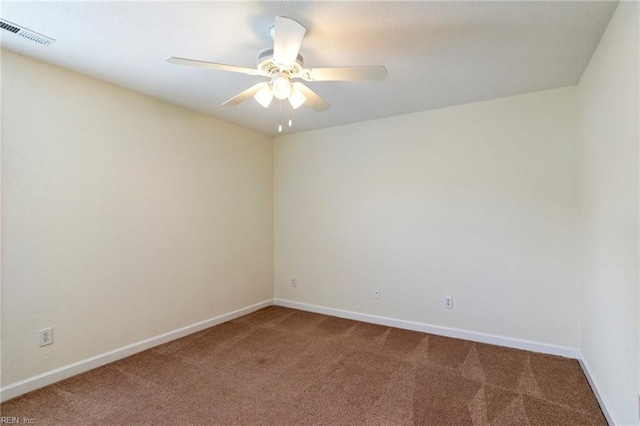 spare room with baseboards, carpet flooring, visible vents, and a ceiling fan