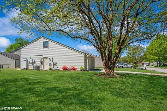 exterior space with a yard, cooling unit, and fence