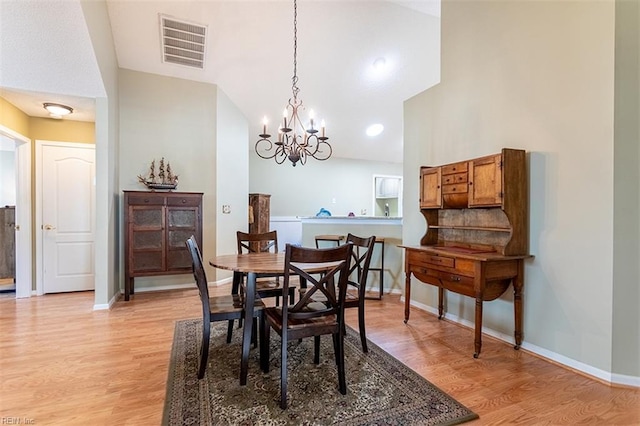 109 Villa Dr, Poquoson, VA 23662 - dining room featuring light wood-style floors, a chandelier, baseboards, and lofted ceiling