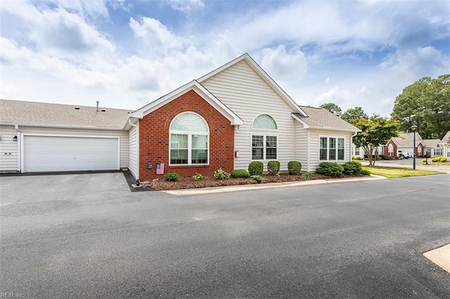 109 Villa Dr, Poquoson, VA 23662 - ranch-style home with asphalt driveway, brick siding, and a garage