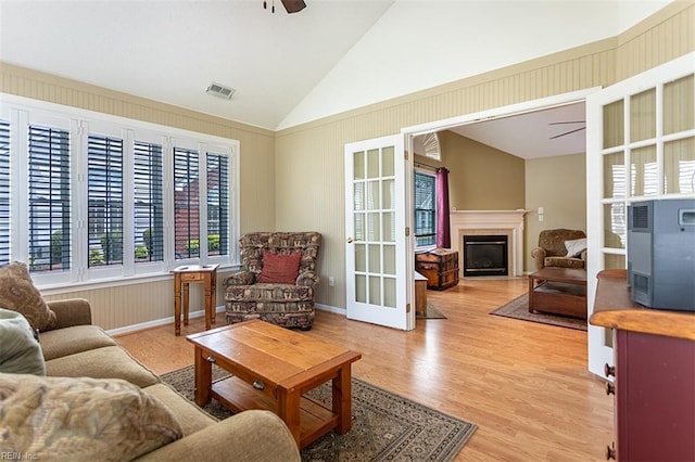 109 Villa Dr, Poquoson, VA 23662 - living room with a ceiling fan, lofted ceiling, a glass covered fireplace, and light wood-style flooring