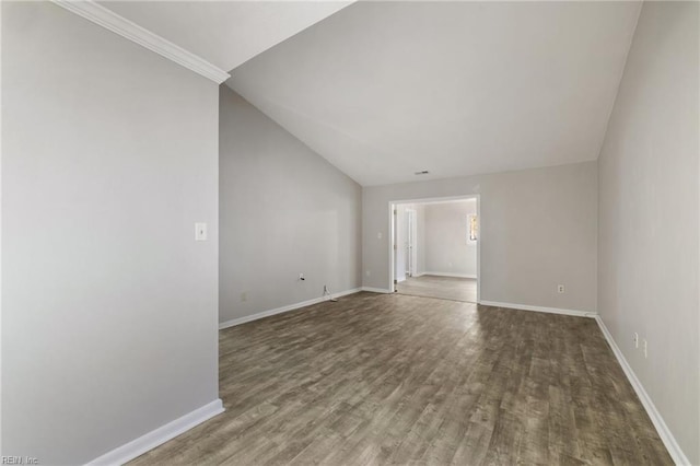 unfurnished room with wood finished floors, baseboards, and lofted ceiling