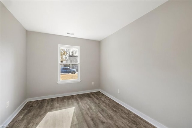 unfurnished room featuring wood finished floors and baseboards