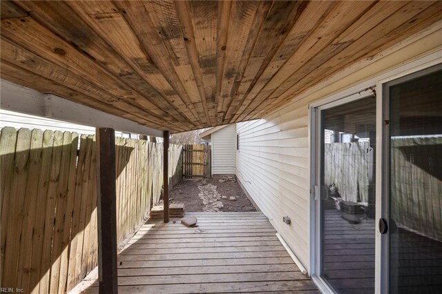 wooden terrace featuring fence